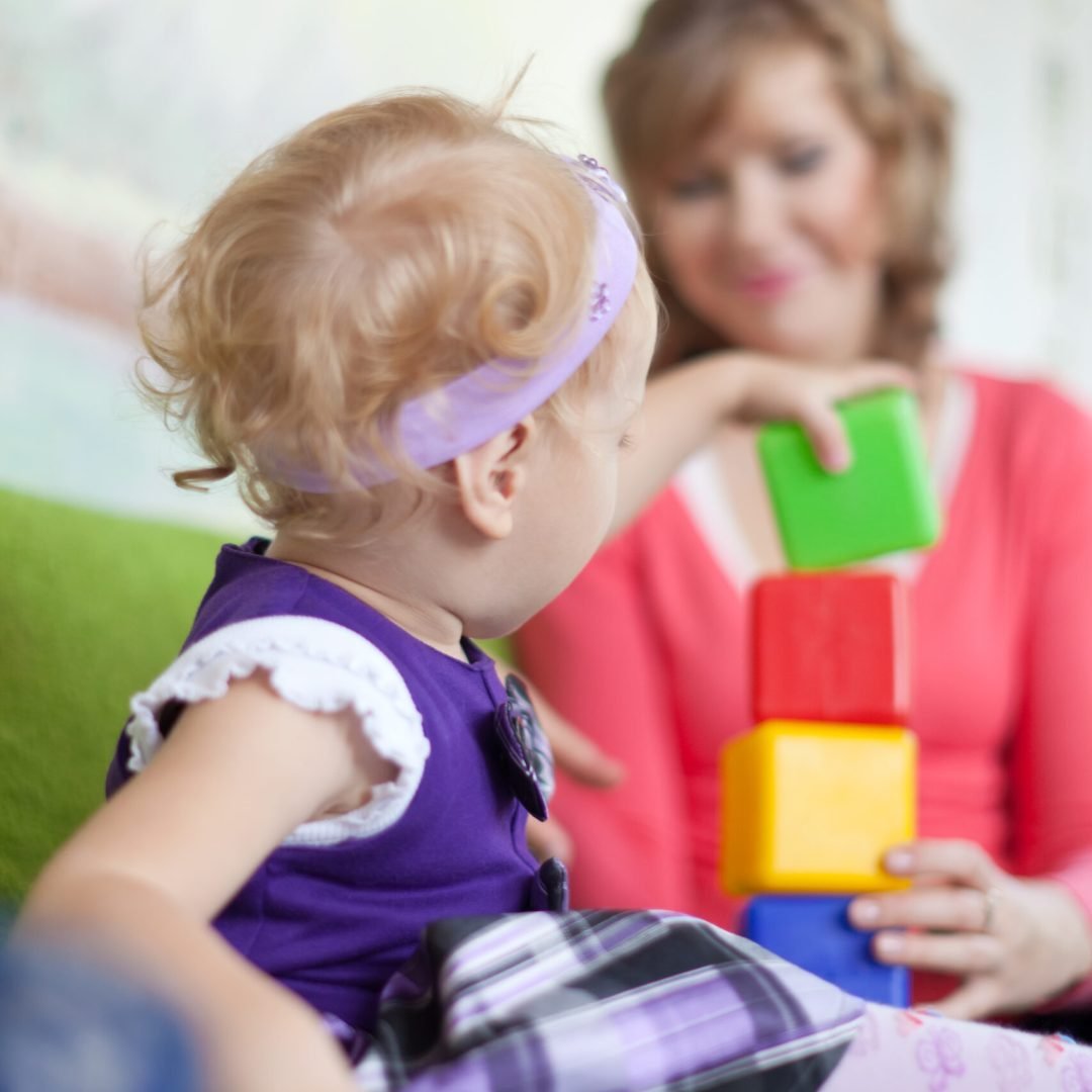 baby girl with mother in home interior